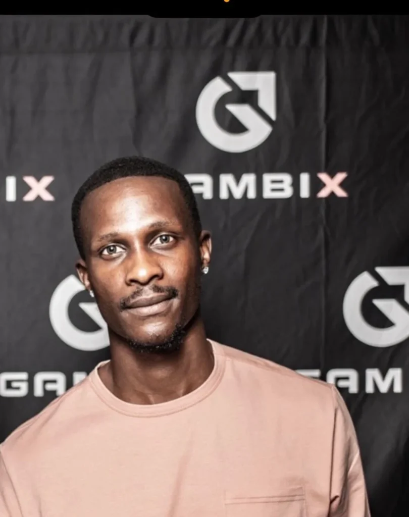 Man standing in front of a Gambix branded backdrop at a startup event